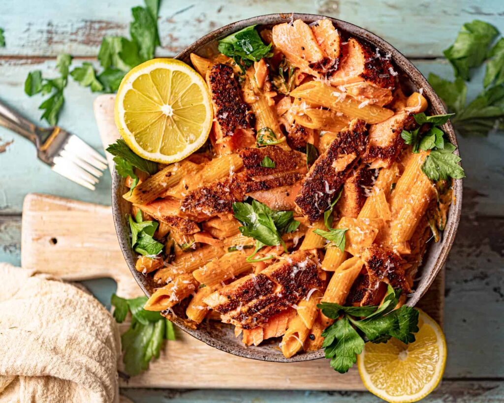 Cajun pasta with salmon on a plate.