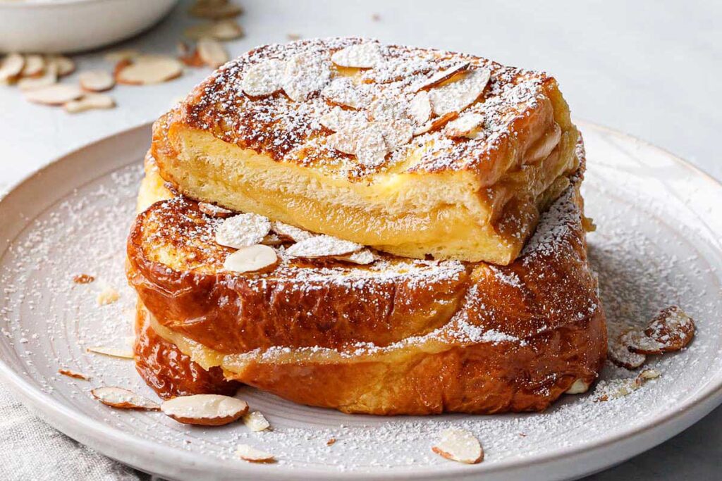 Stuffed french toast on a plate with marzipan coming out.
