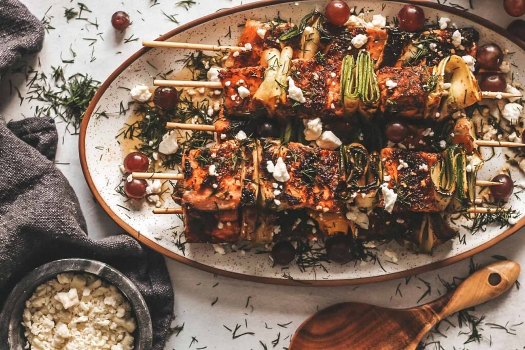 Salmon skewers on a plate.