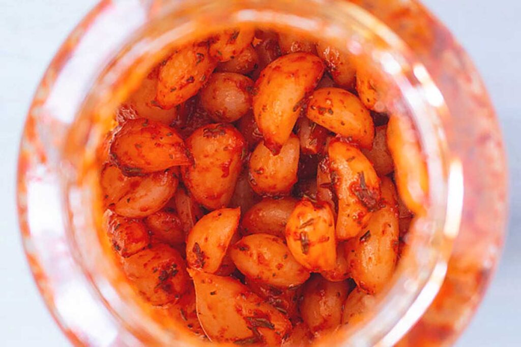 Overhead shot of pickled garlic in a jar