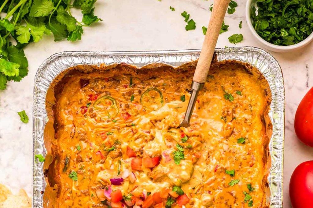 Smoked queso dip on a white bowl.