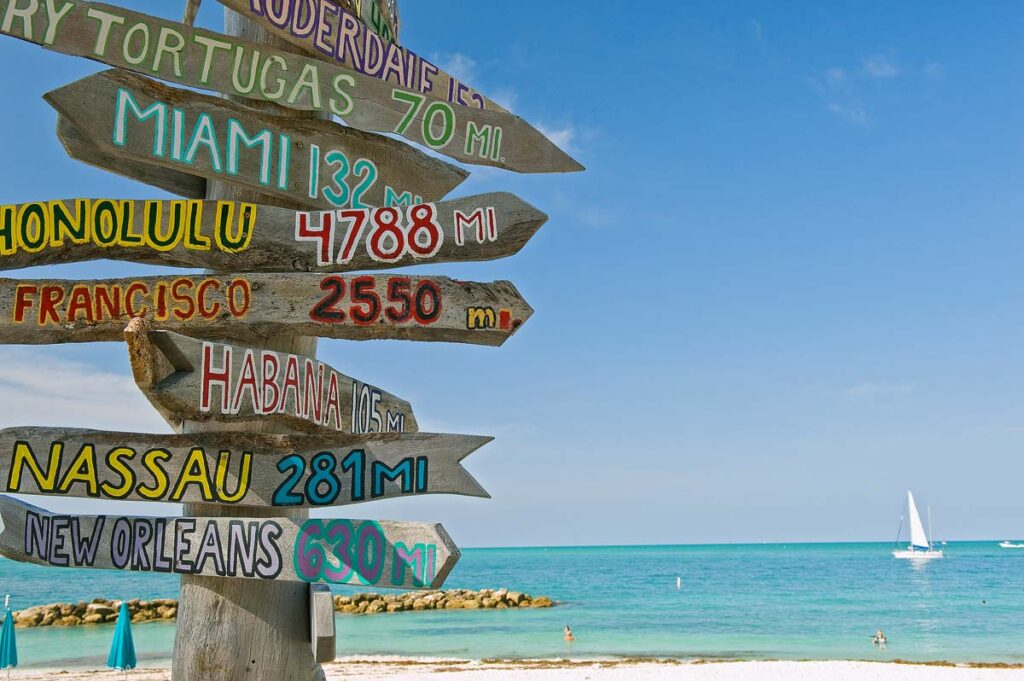 Mileage signpost on key west florida beach.