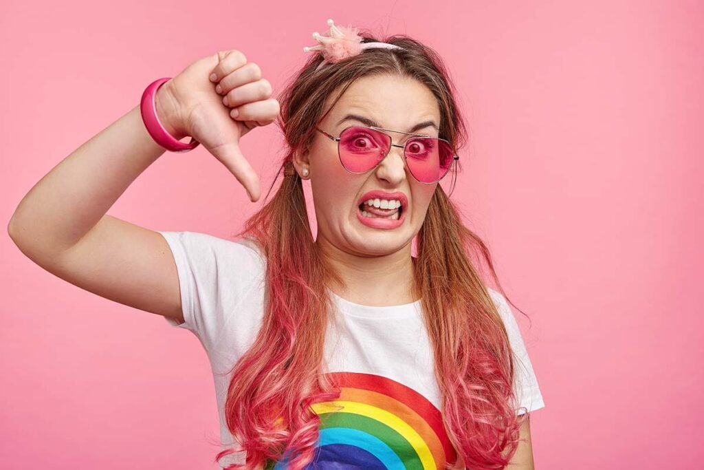 Fashionable woman shows disapproval sign.