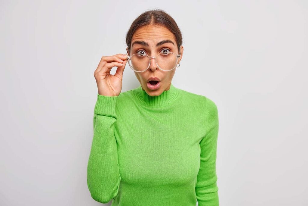 Brunette young woman stares in complete disbelief. 