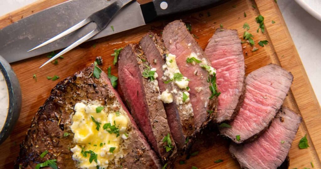 A london broil steak cut into strips.