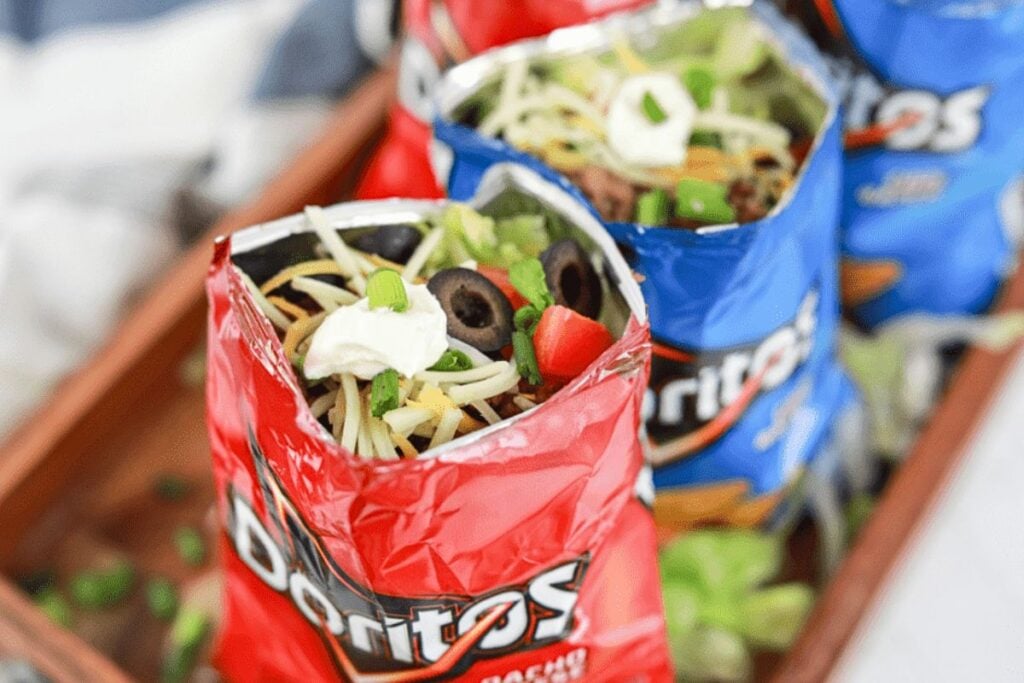 Bags of dorito chips with taco toppings inside.