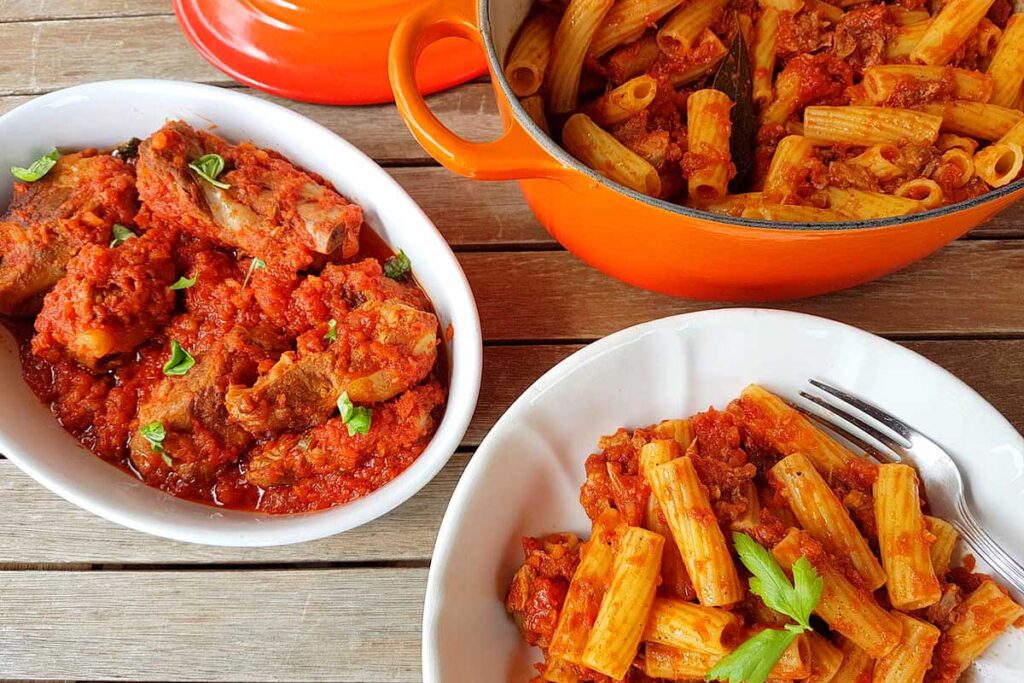 A dish of Italian ribs with pasta on the side.