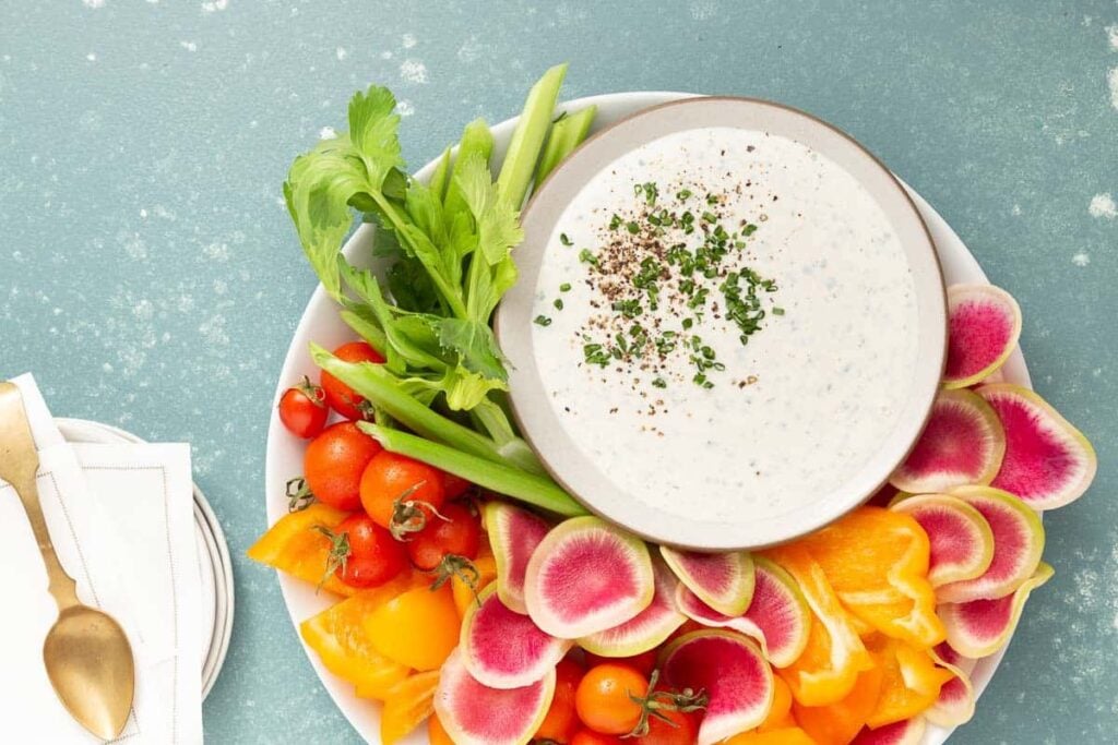 A dish of buttermilk ranch dip with veggies.