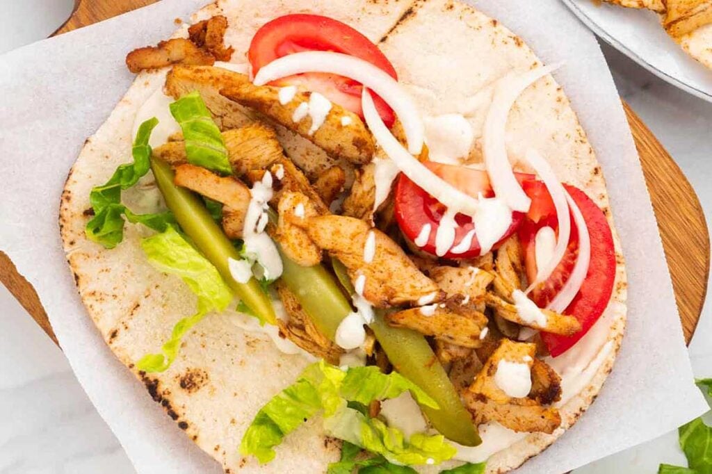 Chicken shawarma on a white plate.