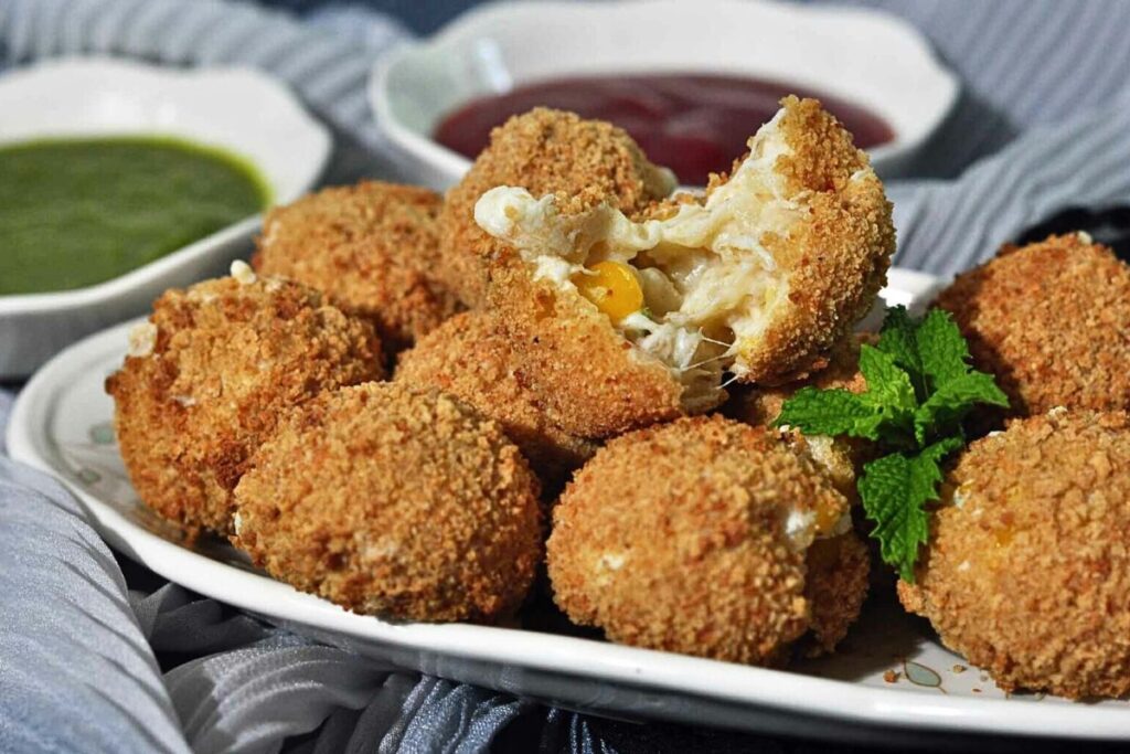 A plate of cheesy corn balls.