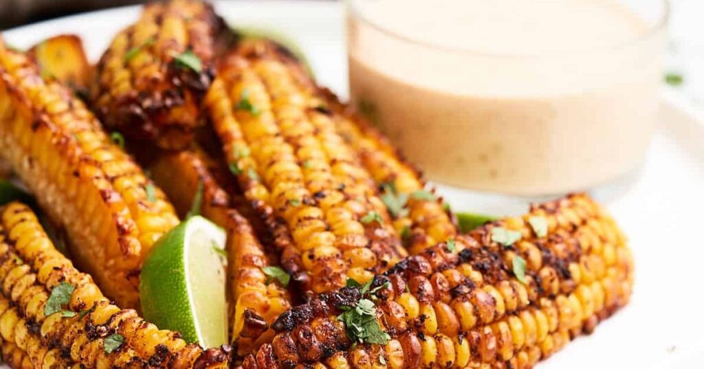 A platter of corn ribs with seasonings.