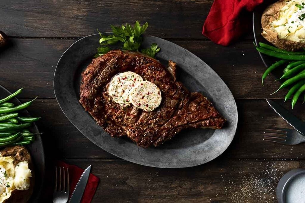 A perfectly grilled ribeye steak with compund butter.