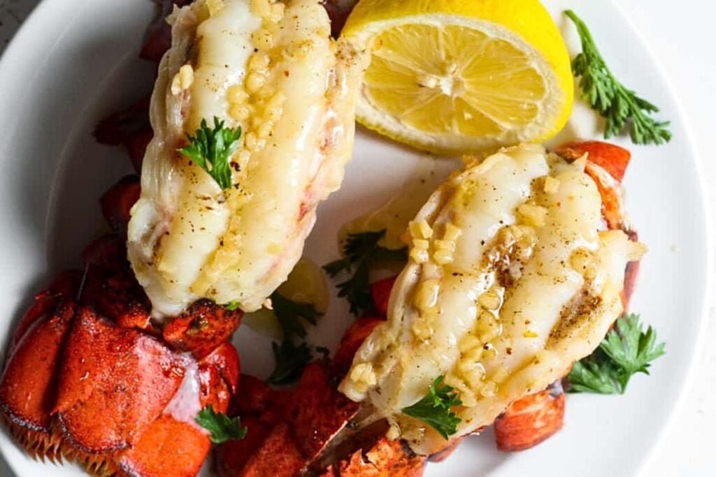 Lobster tails with garlic butter on top.