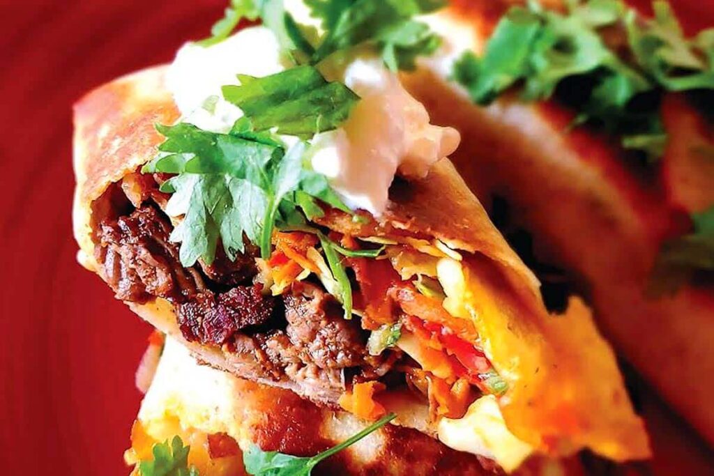 Close view of a burrito cut in half.