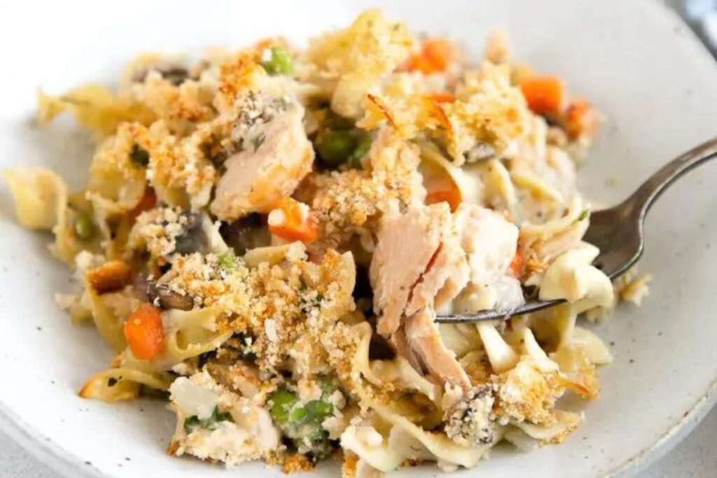 A scoop of tuna noodle casserole on a plate.