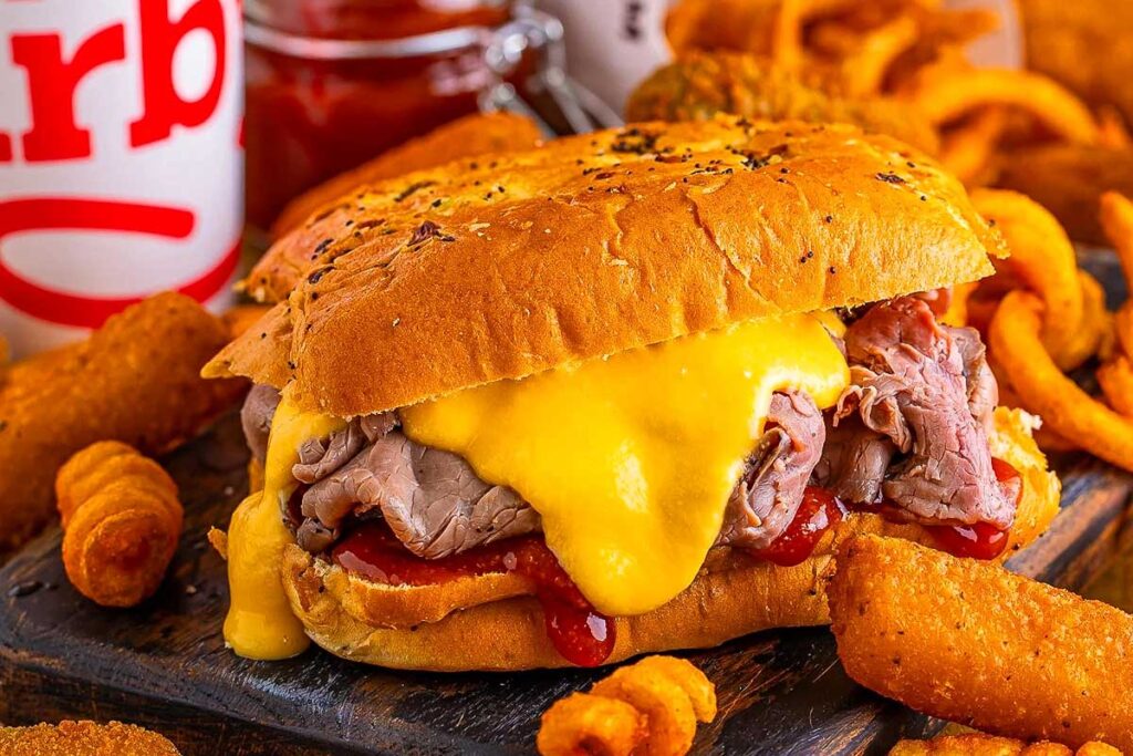 Arby beef and cheese on a plate with fries.