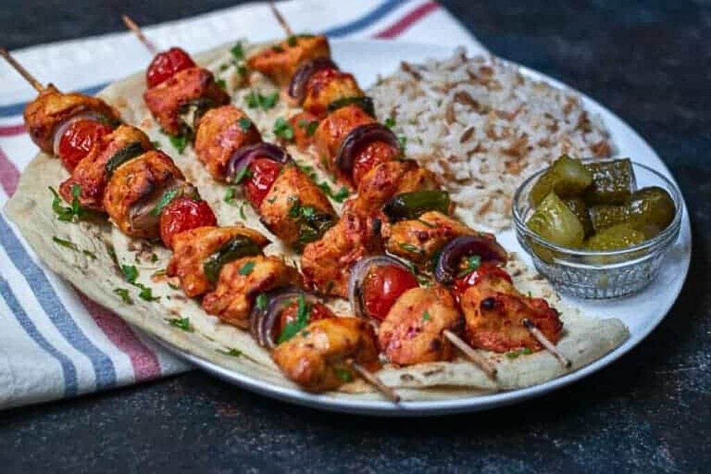Turkish chicken kabobs on a plate.
