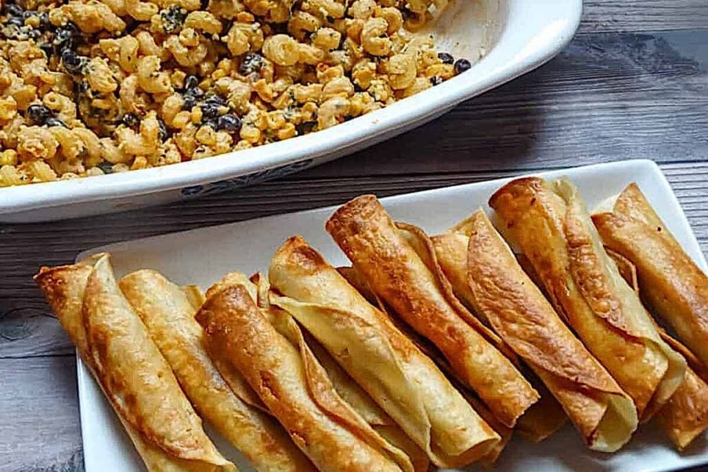 A platter of crispy chicken taquitos.