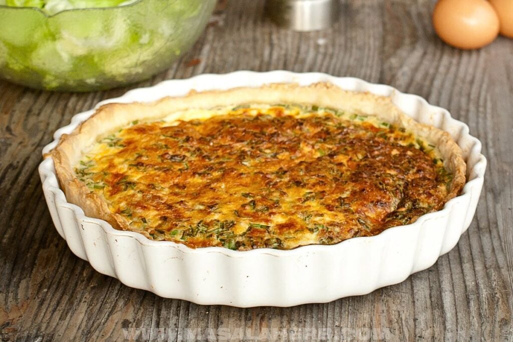A quiche lorraine in a pie pan.
