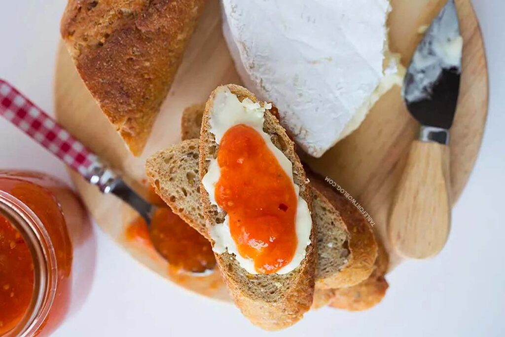 Spicy tomato peach jam on a small slice of bread.