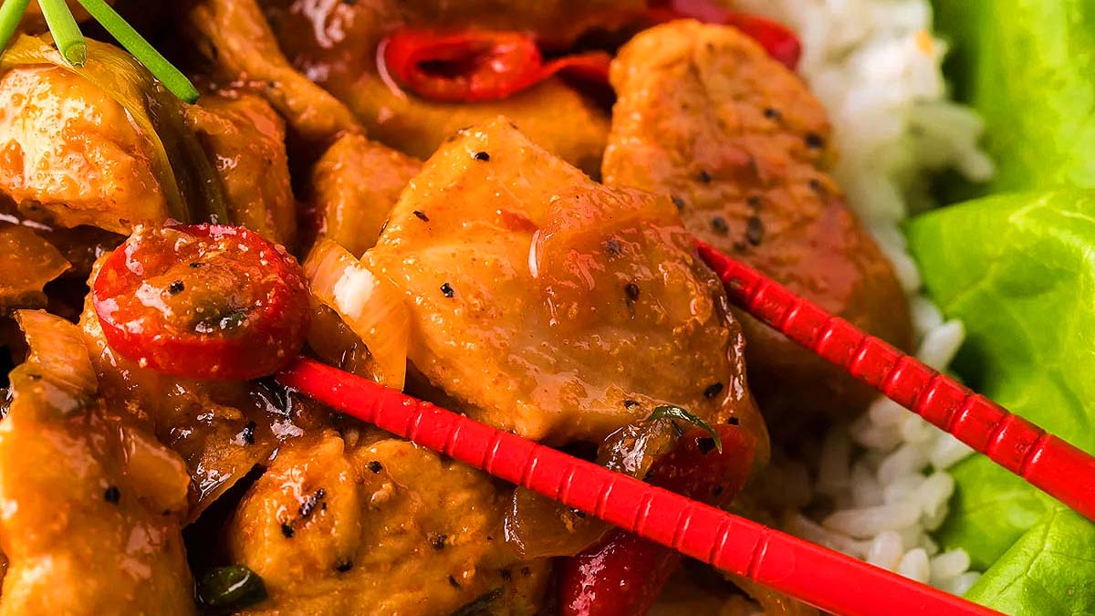 Spicy gochujang chicken stir fry served on lettuce leaves.