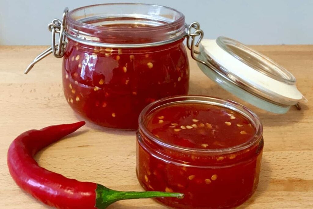 Two small jars of chili sauce.
