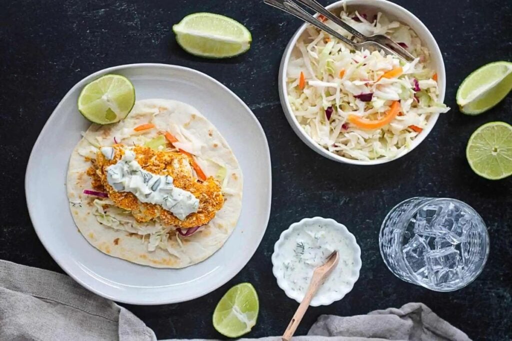 A taco filled with crispy cauliflower, cabbage and creamy sauce.