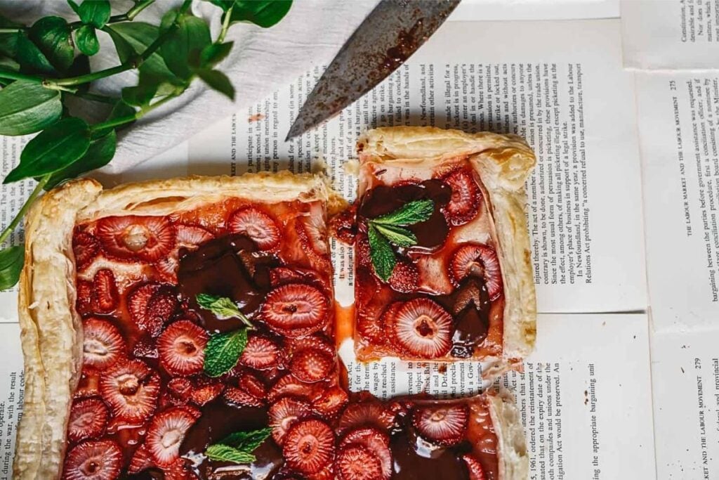 A berry tart with chocolate, cut into squares.