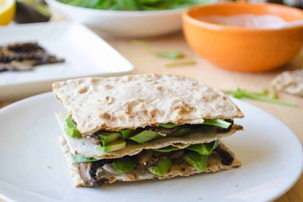 Sandwich made of mushrooms and avocados.