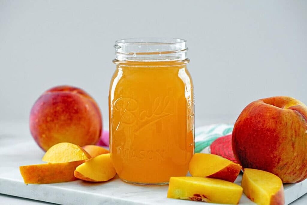 A jar of peach simple syrup.