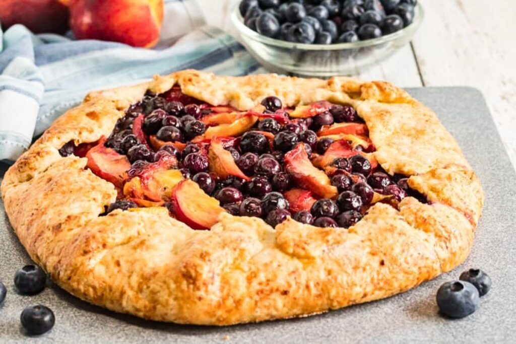 A galette made of peaches and blueberries.