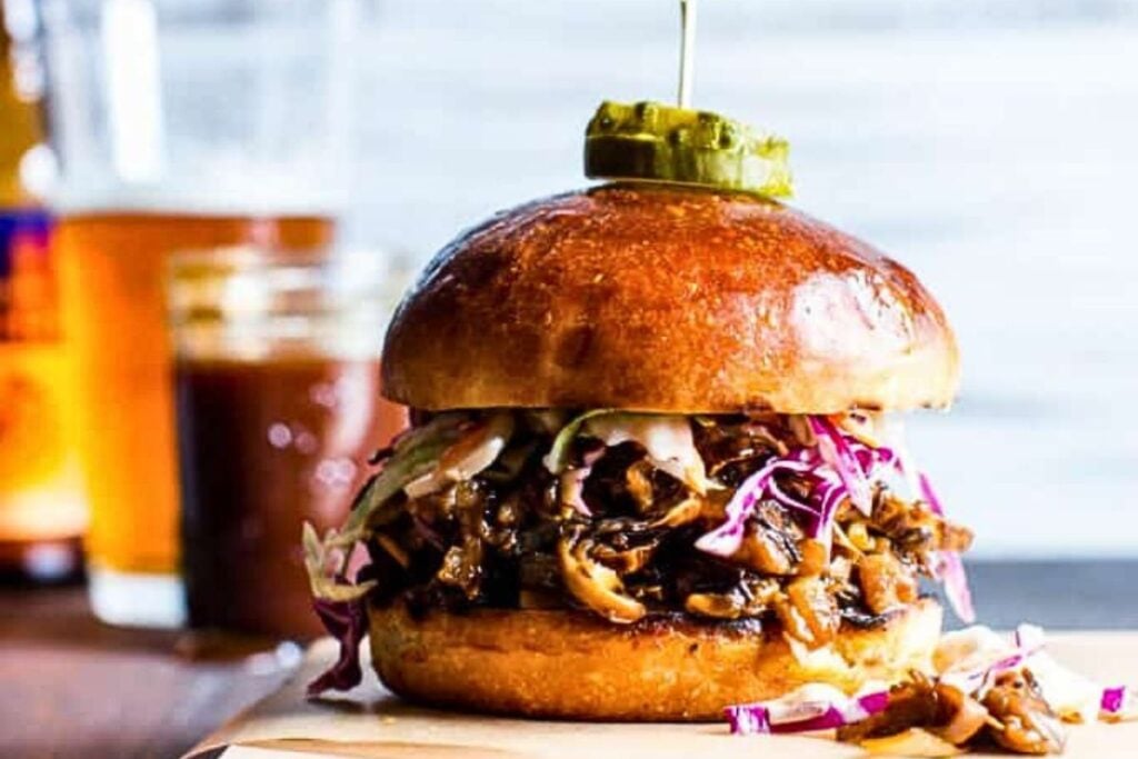 A vegan pulled pork sandwich made with portobello mushrooms.