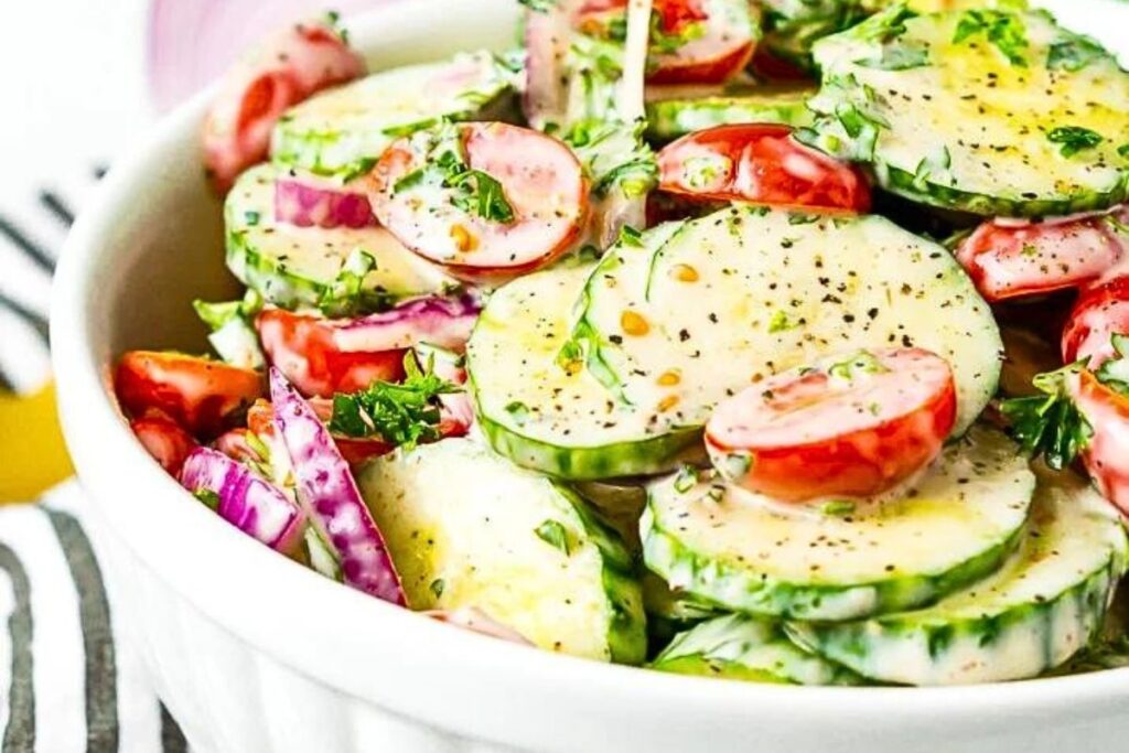 A bowl of tomato and cucumber salad.