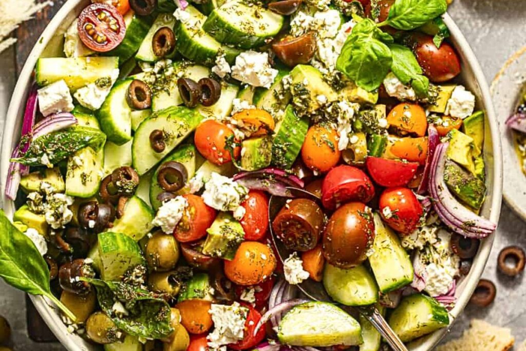 A bowl of greek tomato and cucumber salad.