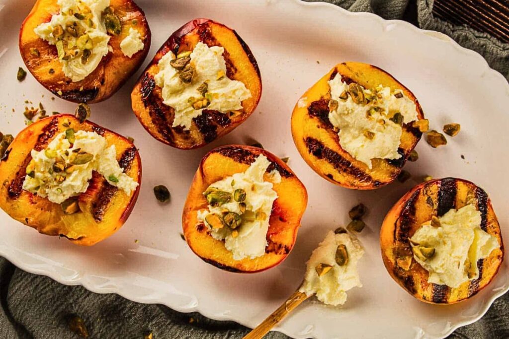 A platter of grilled peaches with mascarpone cheese.