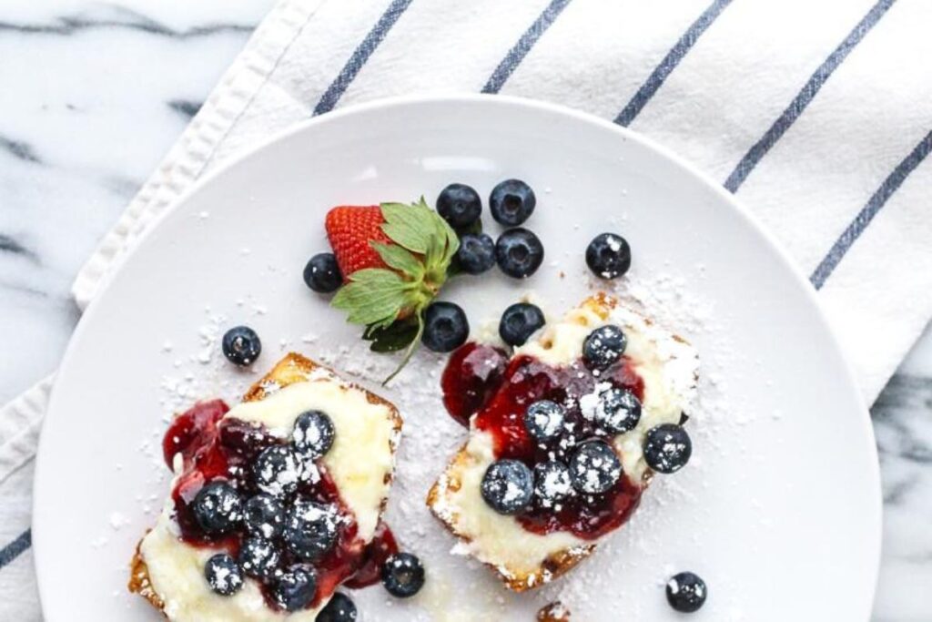 Slices of grilled pound cake with berries and mascarpone cheese.