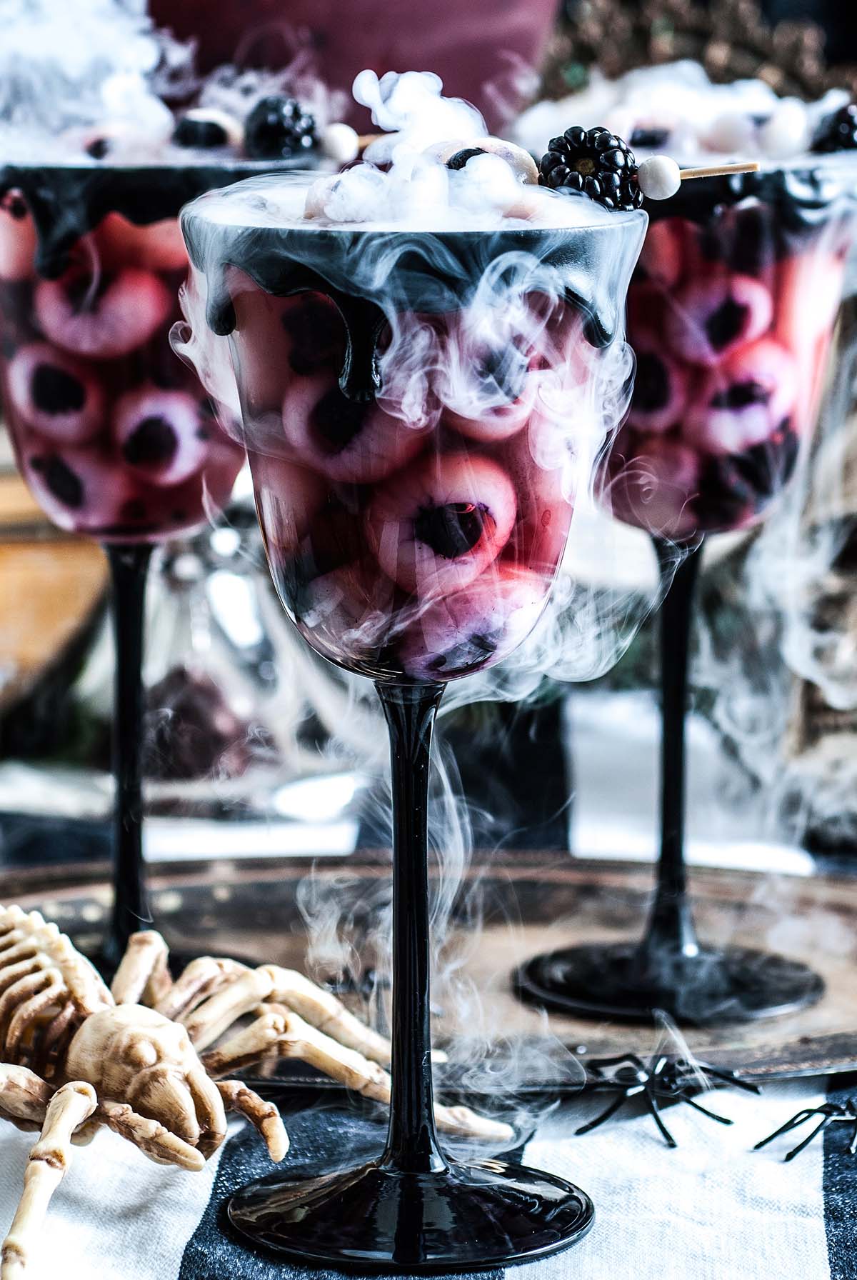Dry ice smoke on glasses of eyeball punch.