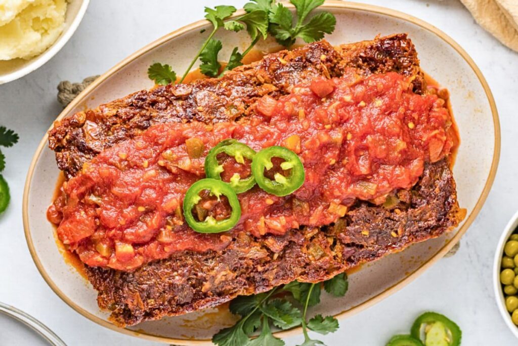 Spicy mexican meatloaf with jalapeno slices on top.