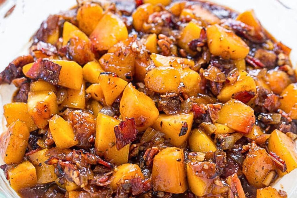 A dish of cream cheese, pecan peach dip.