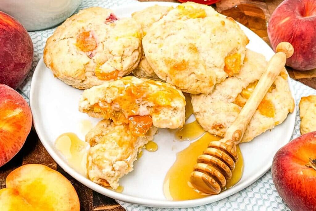 Peach scones on a plate with honey.