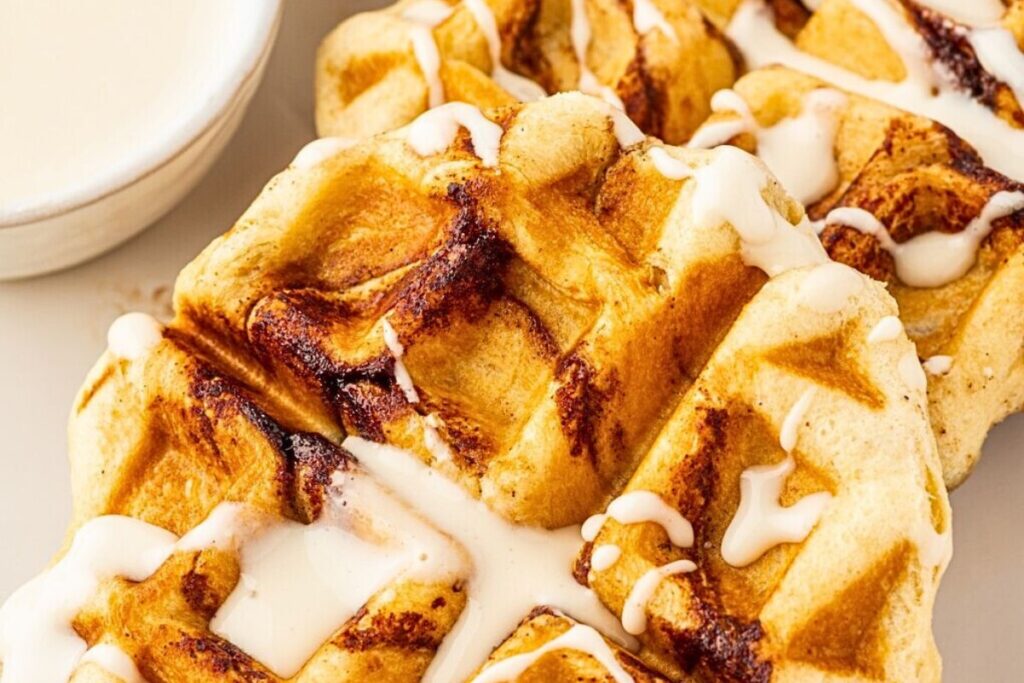 A plate of cinnamon rolls cooked in a waffle iron.