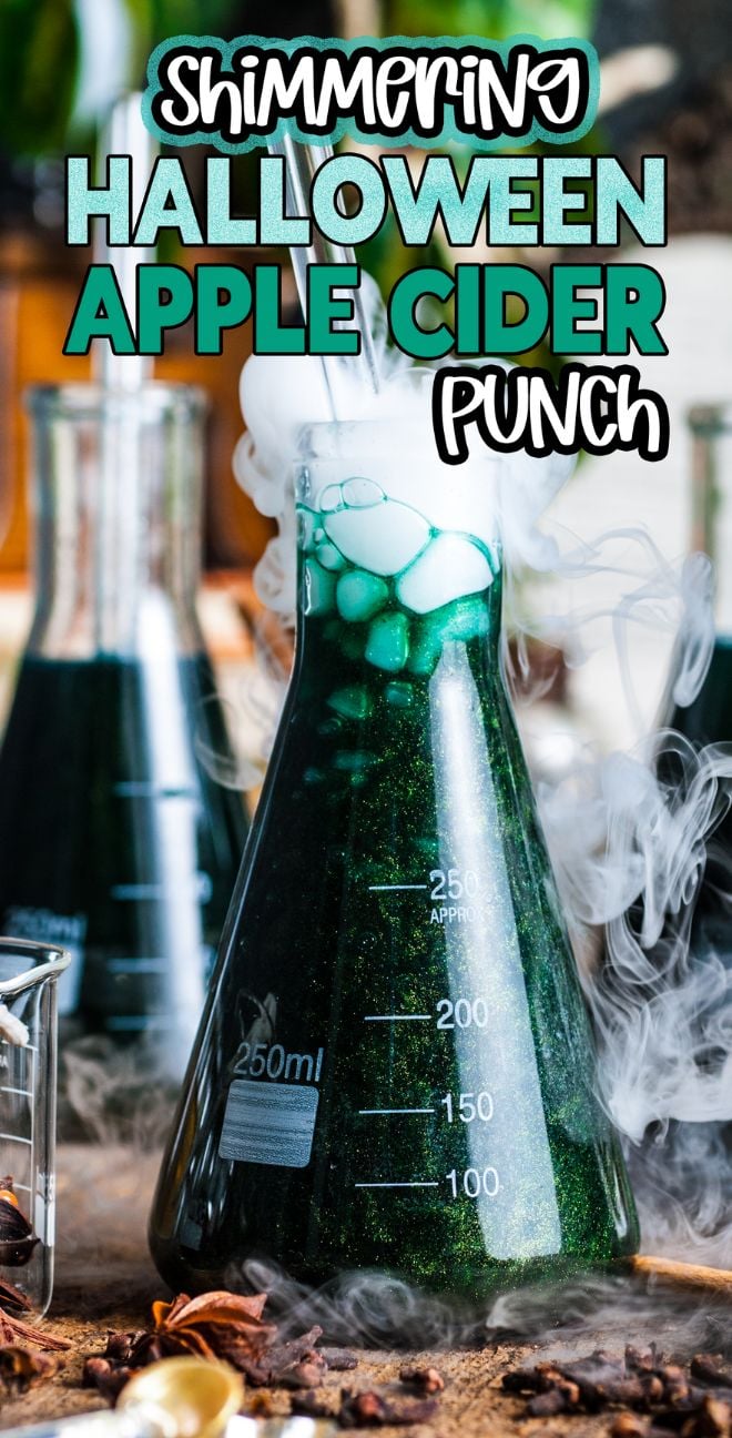 A bubbling green potion in a lab flask with smoke, labeled “Shimmering Halloween apple cider punch,” perfect for spooky gatherings.