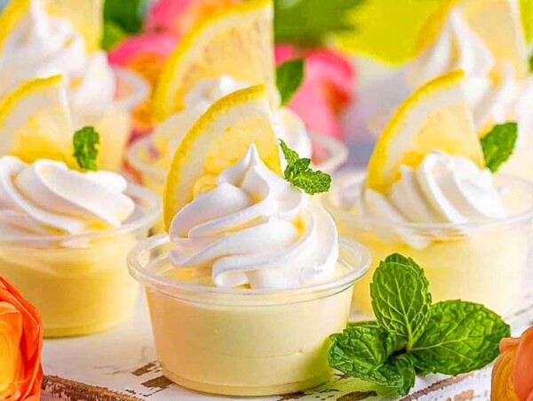 Lemon Pudding Shots with lemon on top.