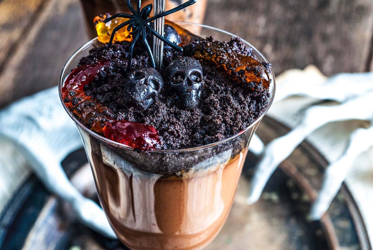 A chocolate pot de creme or Halloween worms and dirt in a wine glass.