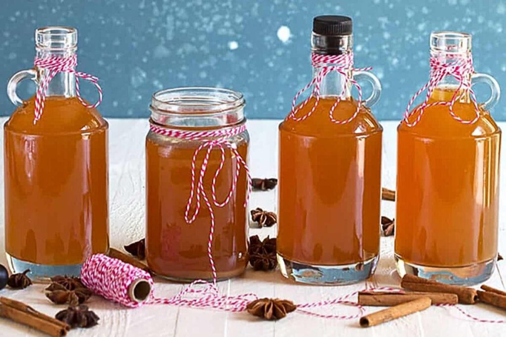 Jars of homemade apple pie moonshine.