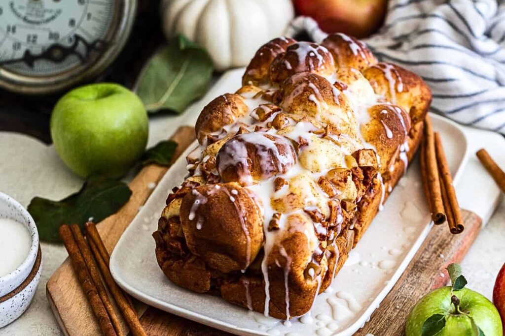 A loaf of apple pear bread with apple cider glaze.
