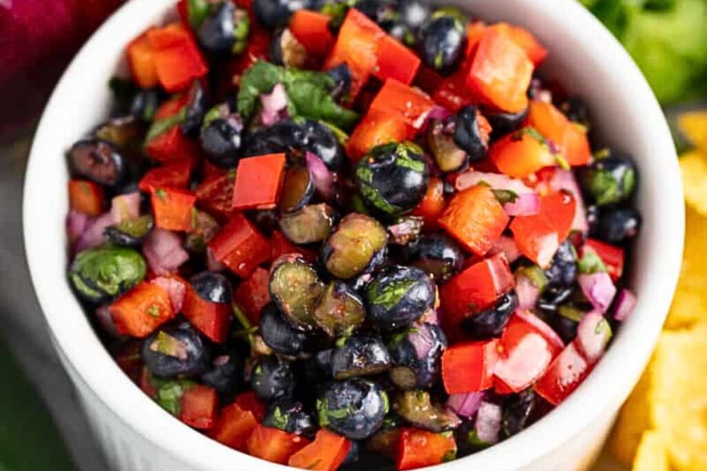 A bowl of blueberry and bell pepper salsa.