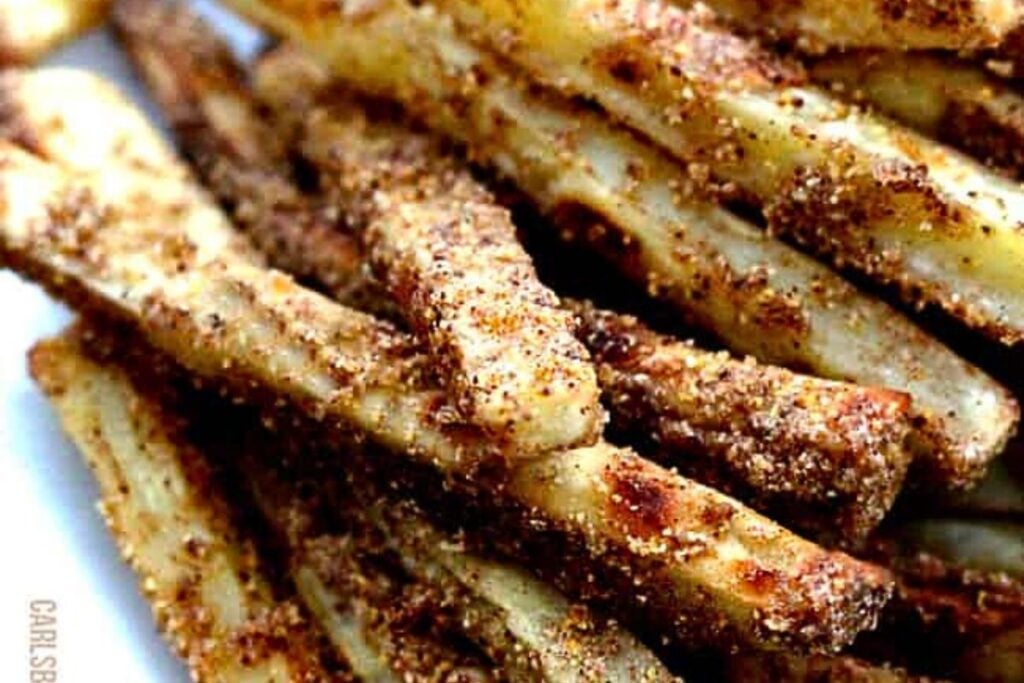 A plate of white sweet potato fries with brown sugar cinnamon coating.