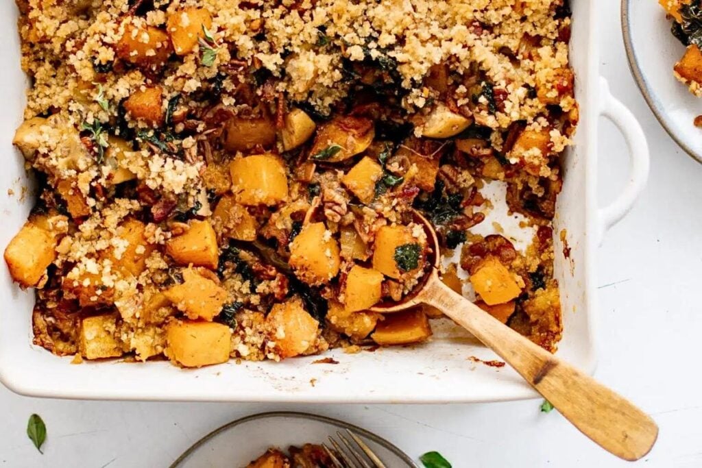 A casserole of butternut squash cubes with a crumb topping.