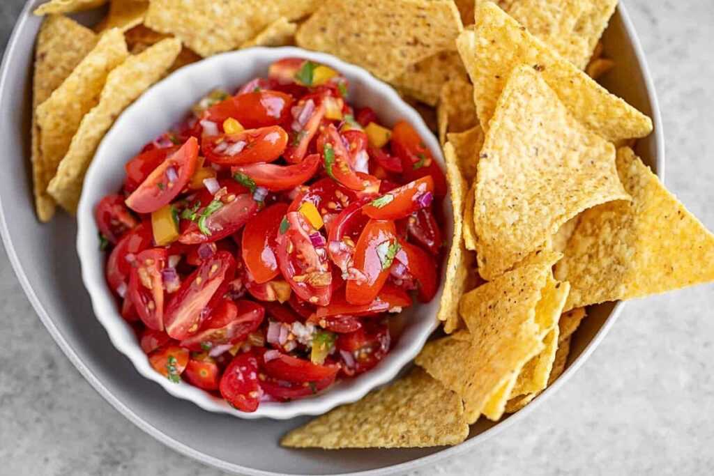 A bowl of chunky cherry tomato salsa.